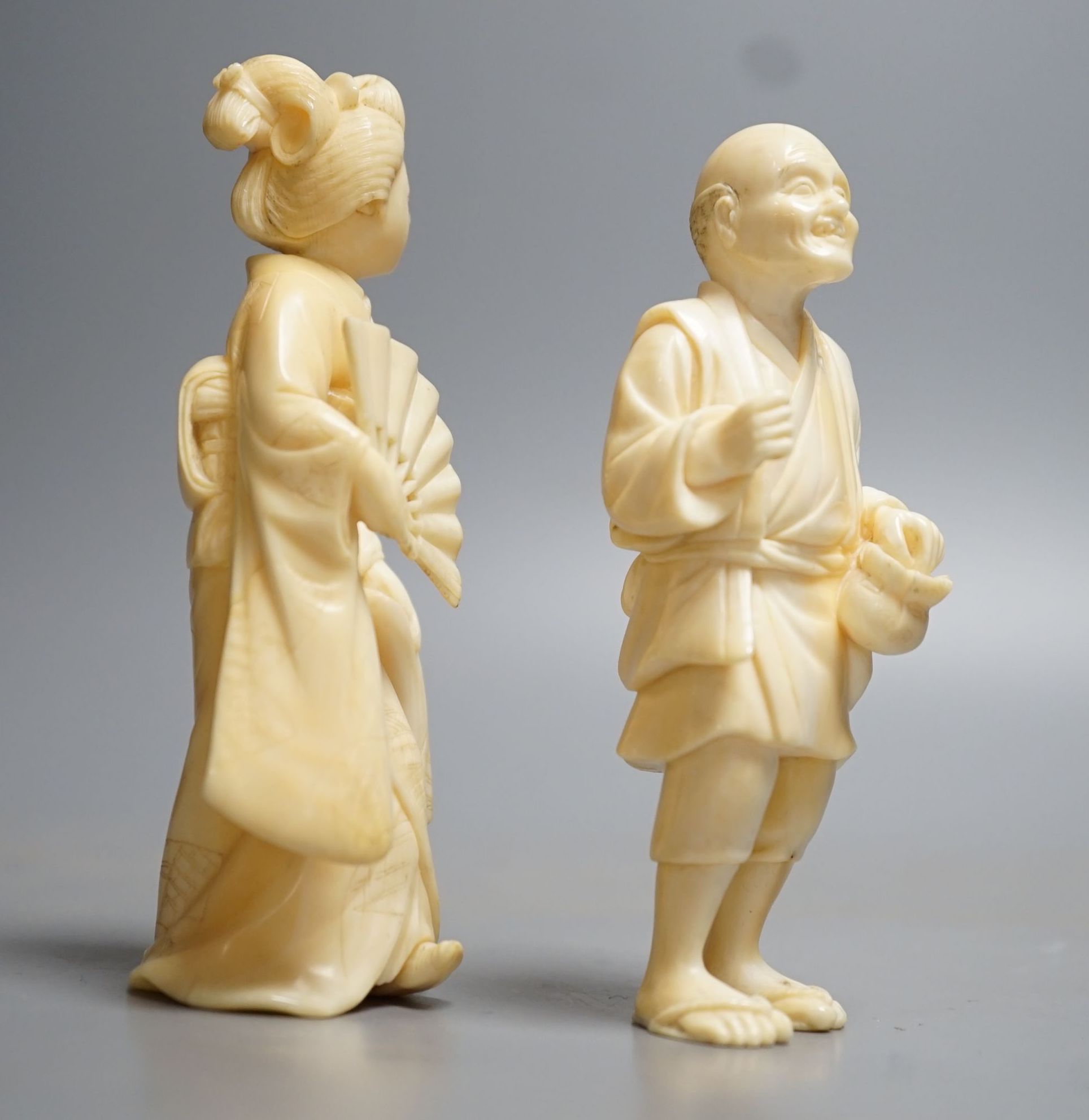 Two Japanese ivory figures of a man and a bijin, Meiji period, both signed to base, 10cm